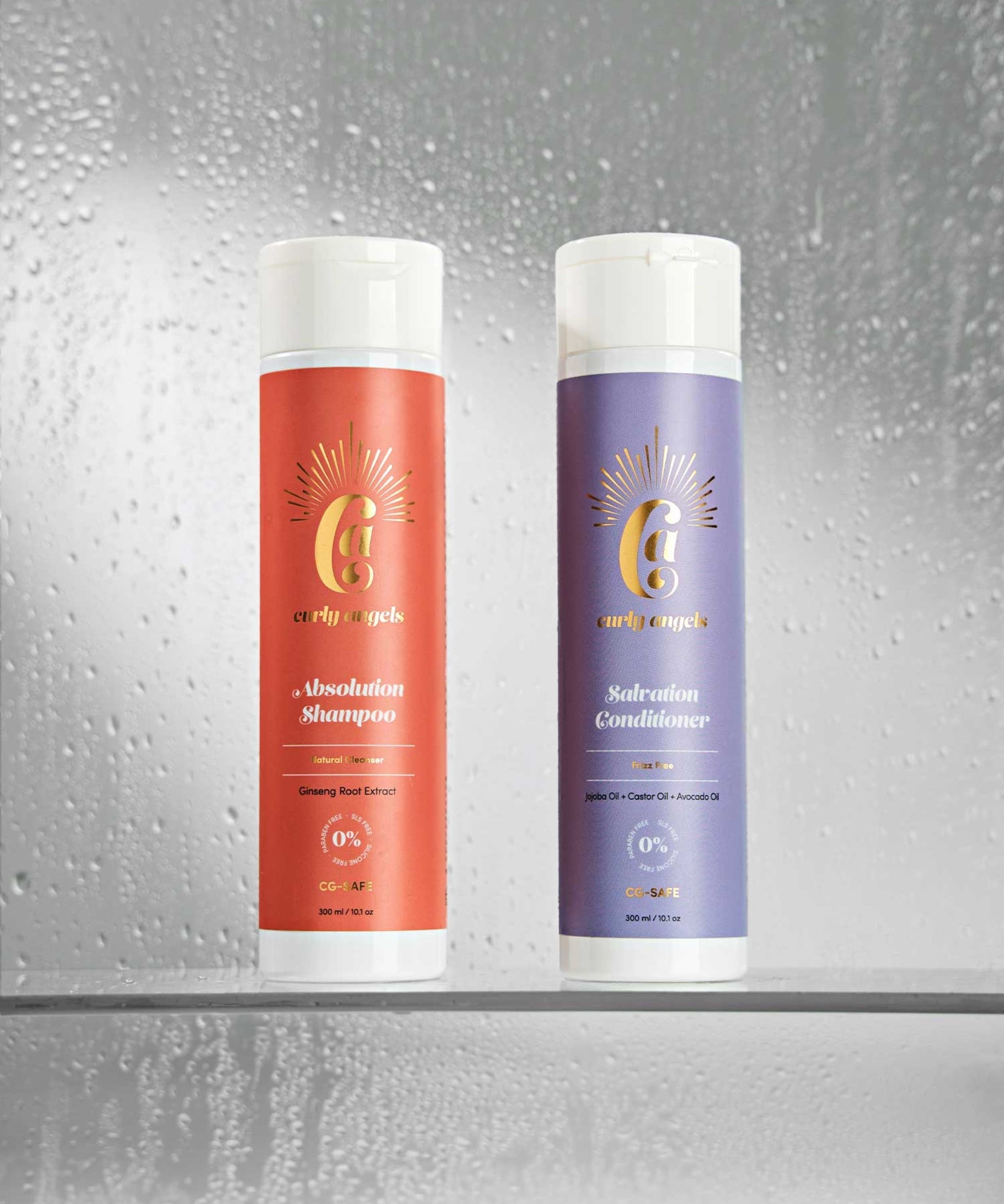 Curly Angels Salvation Conditioner picture atop stacked marble with two purple flowers balanced against it