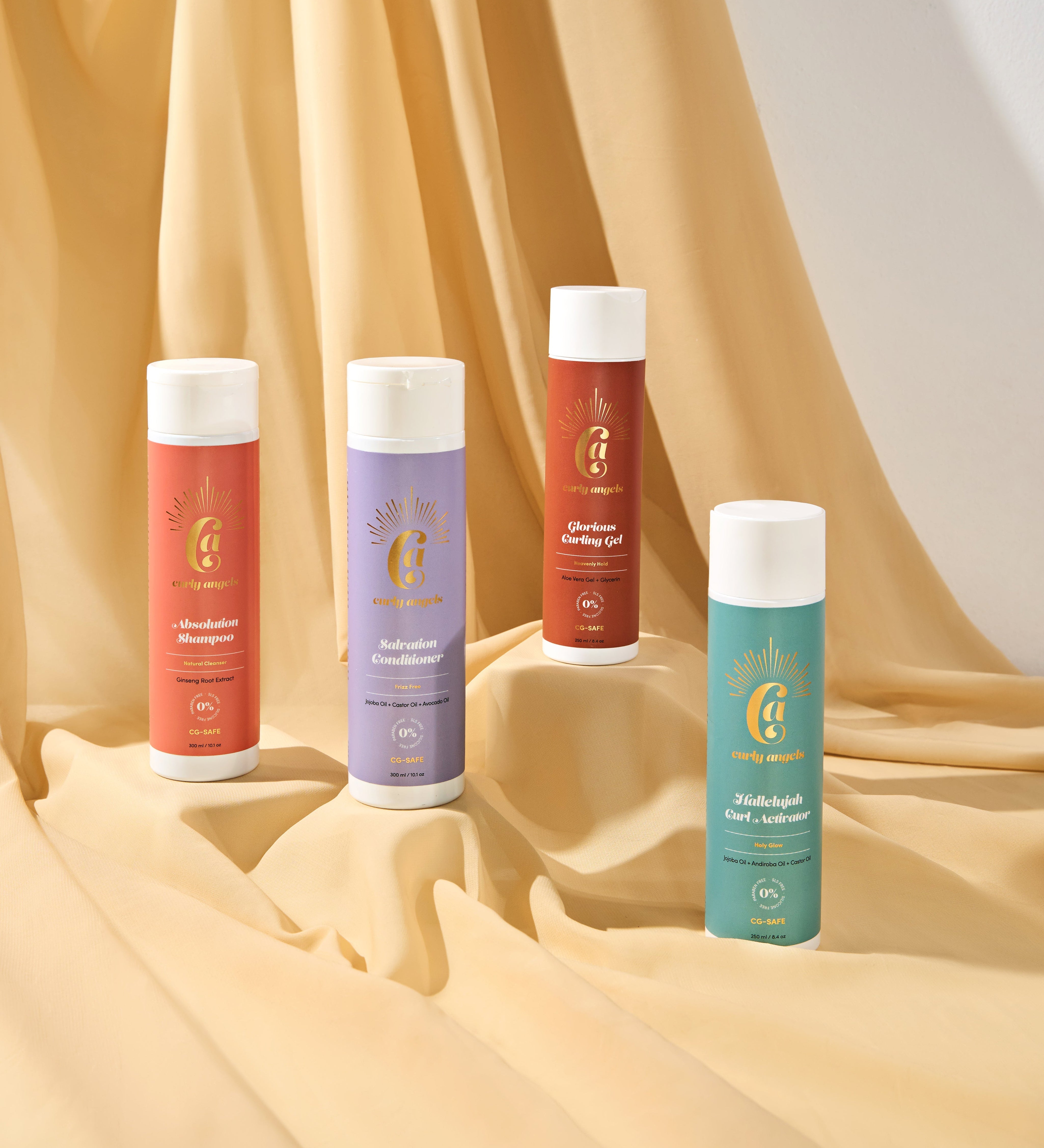 Curly Angels Collection Set Against of Four Haircare Products against a Golden Fabric Backdrop Showing 