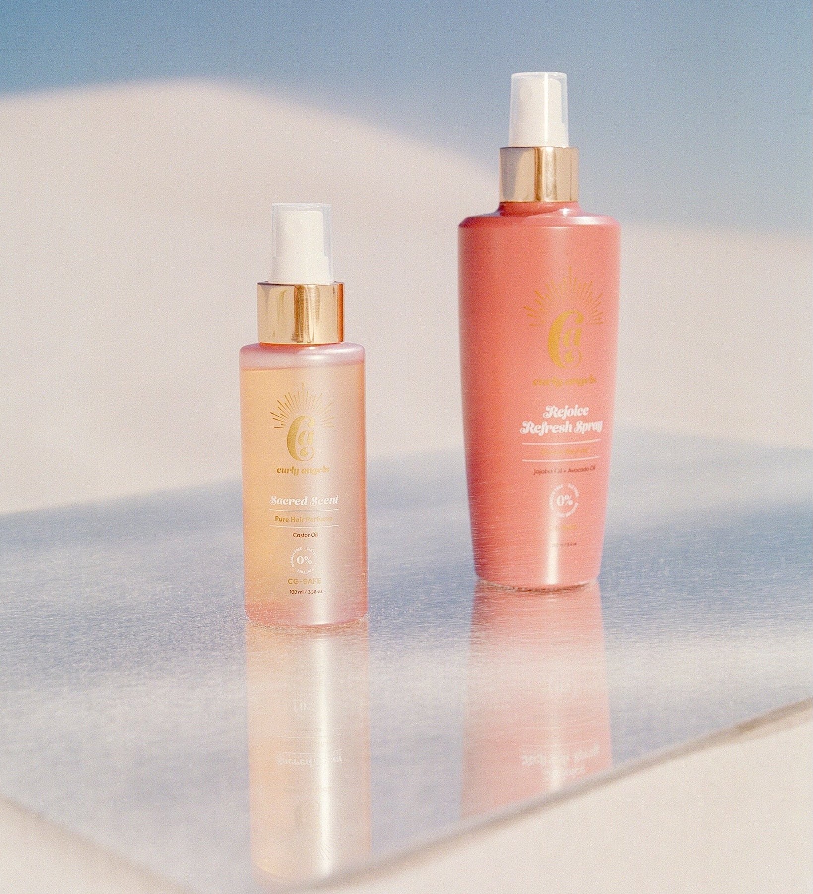 Curly Angels Rejoice Refresh Spray And Sacred Scent against pink tiles