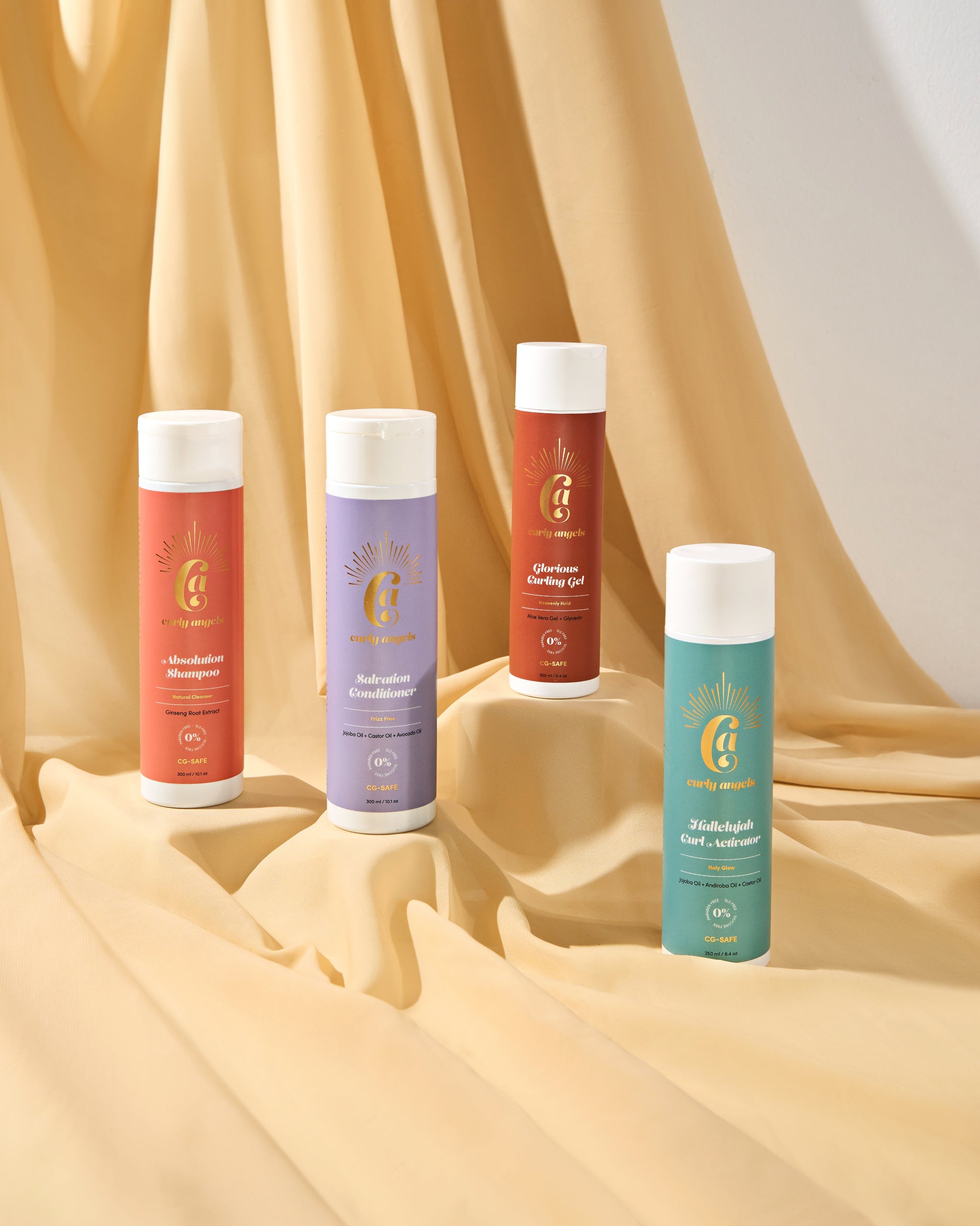The Curly Angels Classic Set, featuring Absolution Shampoo, Salvation Conditioner, Glorious Curling Gel. and Hallelujah Curl activator against a bakdrop of draped fabric - vegan haircare, cruelty-free